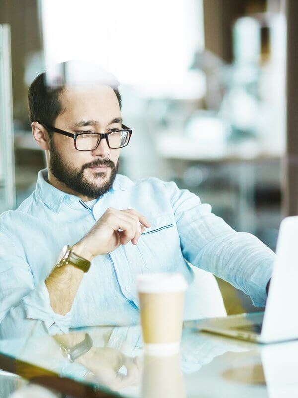 Man looking at data on a computer