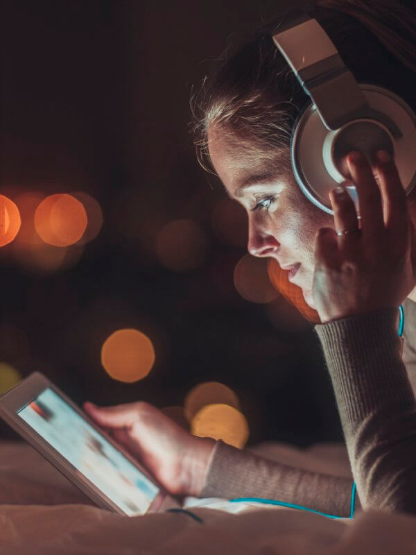 Woman listening to music while browsing on a device