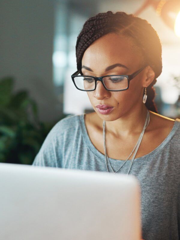 Woman using her laptop to assess the current state of the market