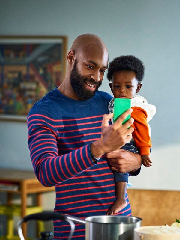 Dad and his child at home taking a video call