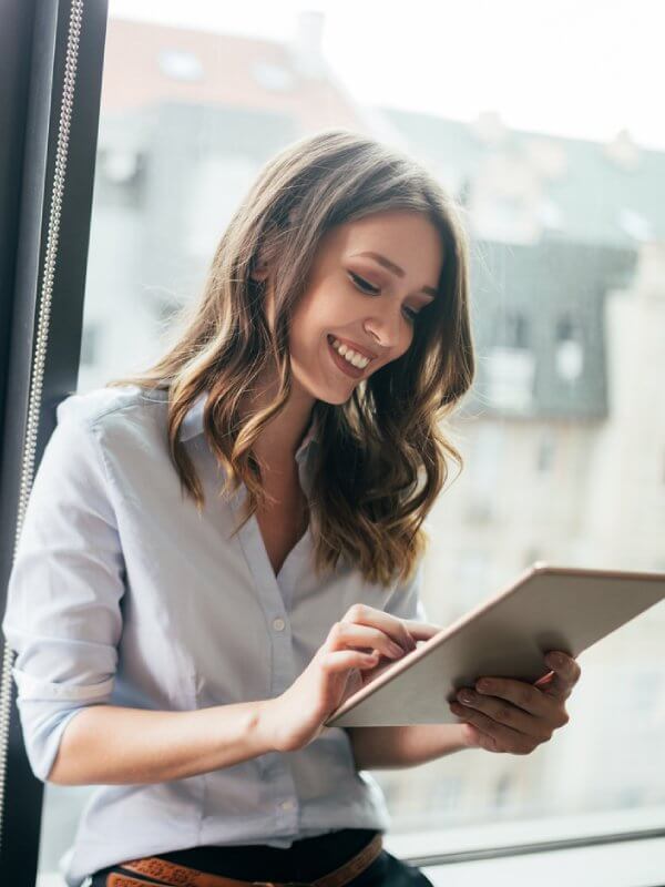 Young woman using a tablet to enrich her company's data