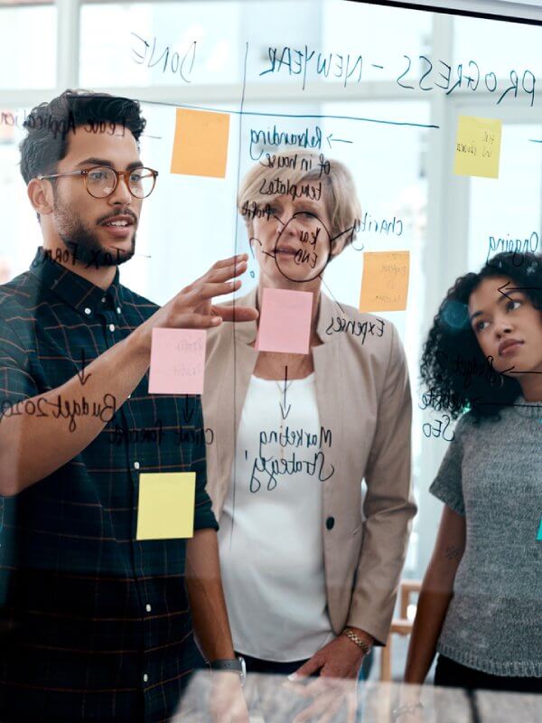 Colleagues looking at notes on a screen