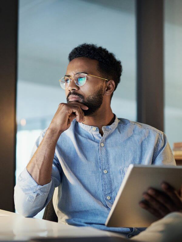 Man looking at data on multiple devices