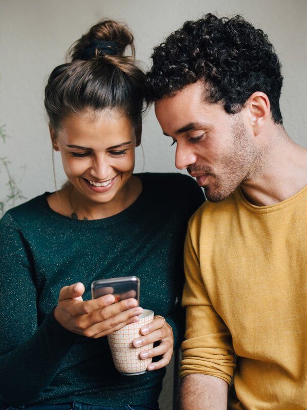 Young couple looking at a mobile phone