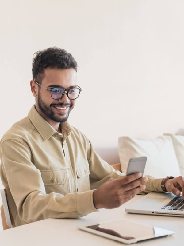 Man lloking happy while using his mobile phone